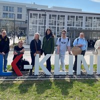 BBW-Auszubildende stehen hinter dem Schriftzug und vor dem Gebäude der SLK-Kliniken in Heilbronn